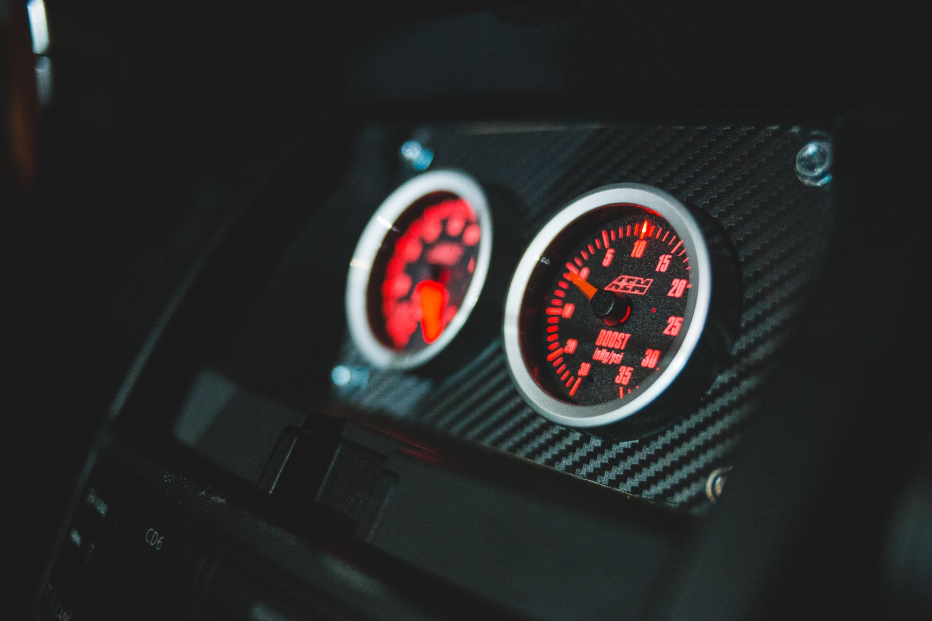 Closeup of colorful control and measuring devices with numbers and scale in modern transport with black interior