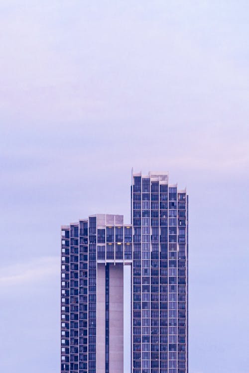 Modern skyscraper against cloudy sky