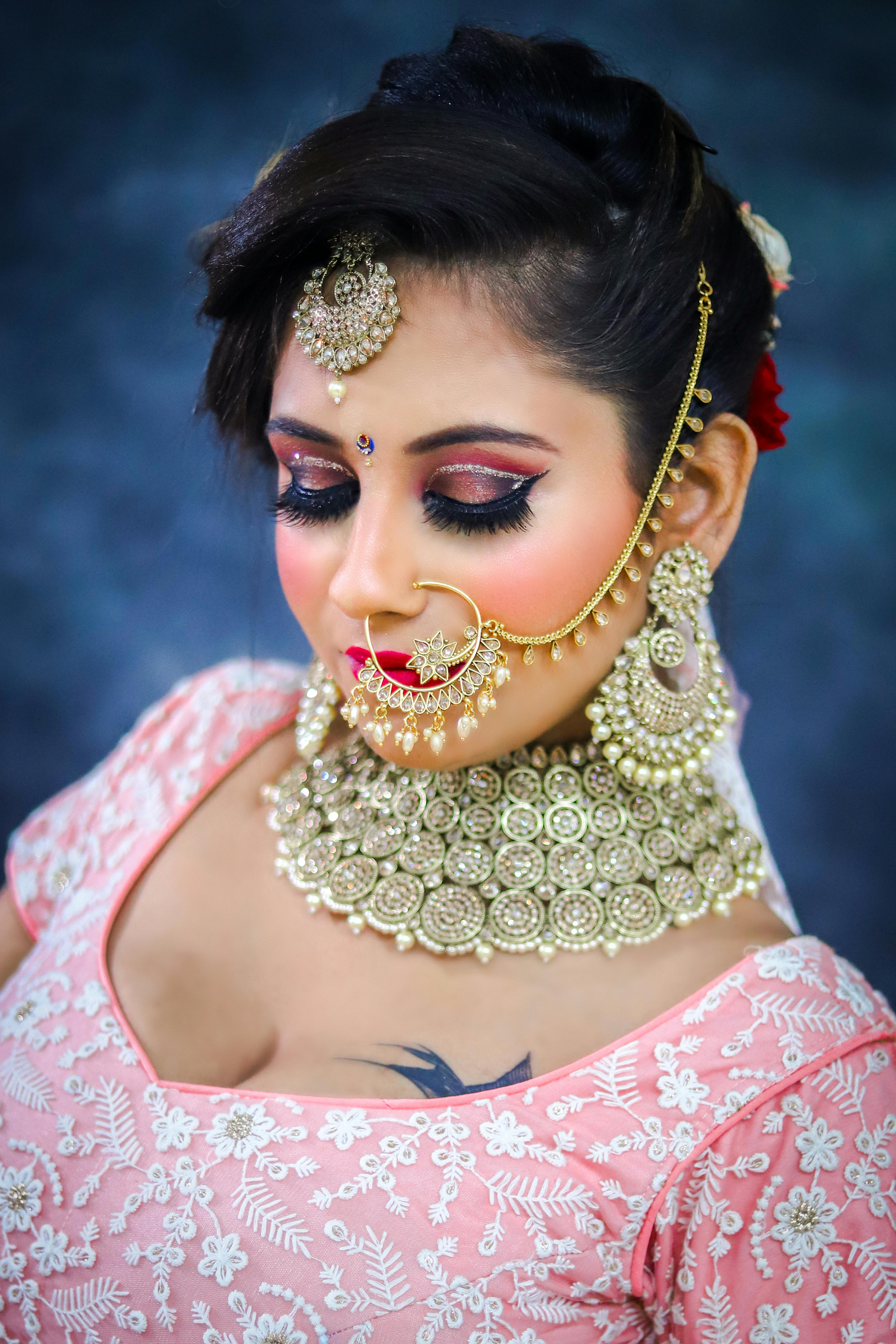 Indian bride in traditional clothes with jewelries covered in makeup · Free  Stock Photo