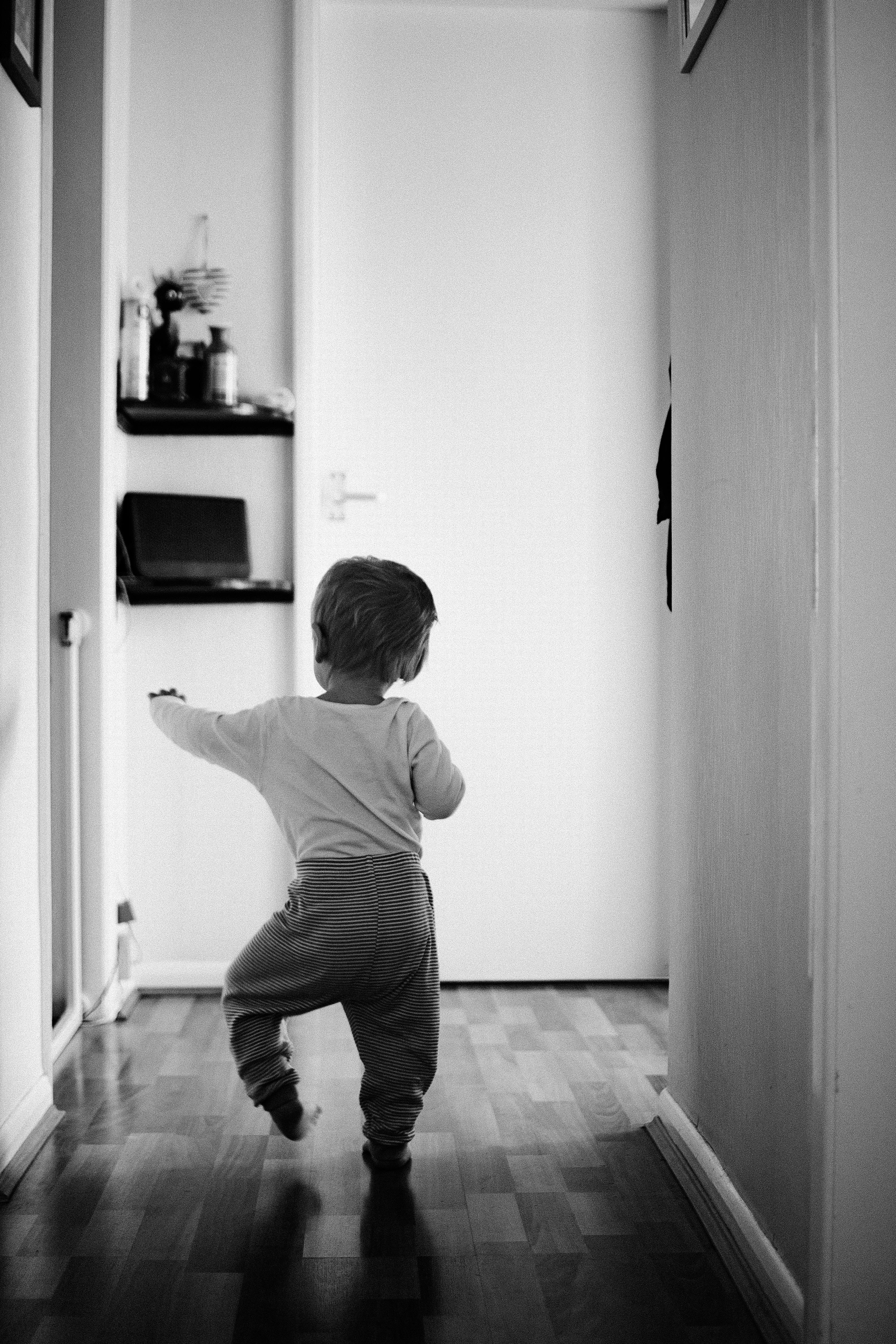 little boy walking away in the room