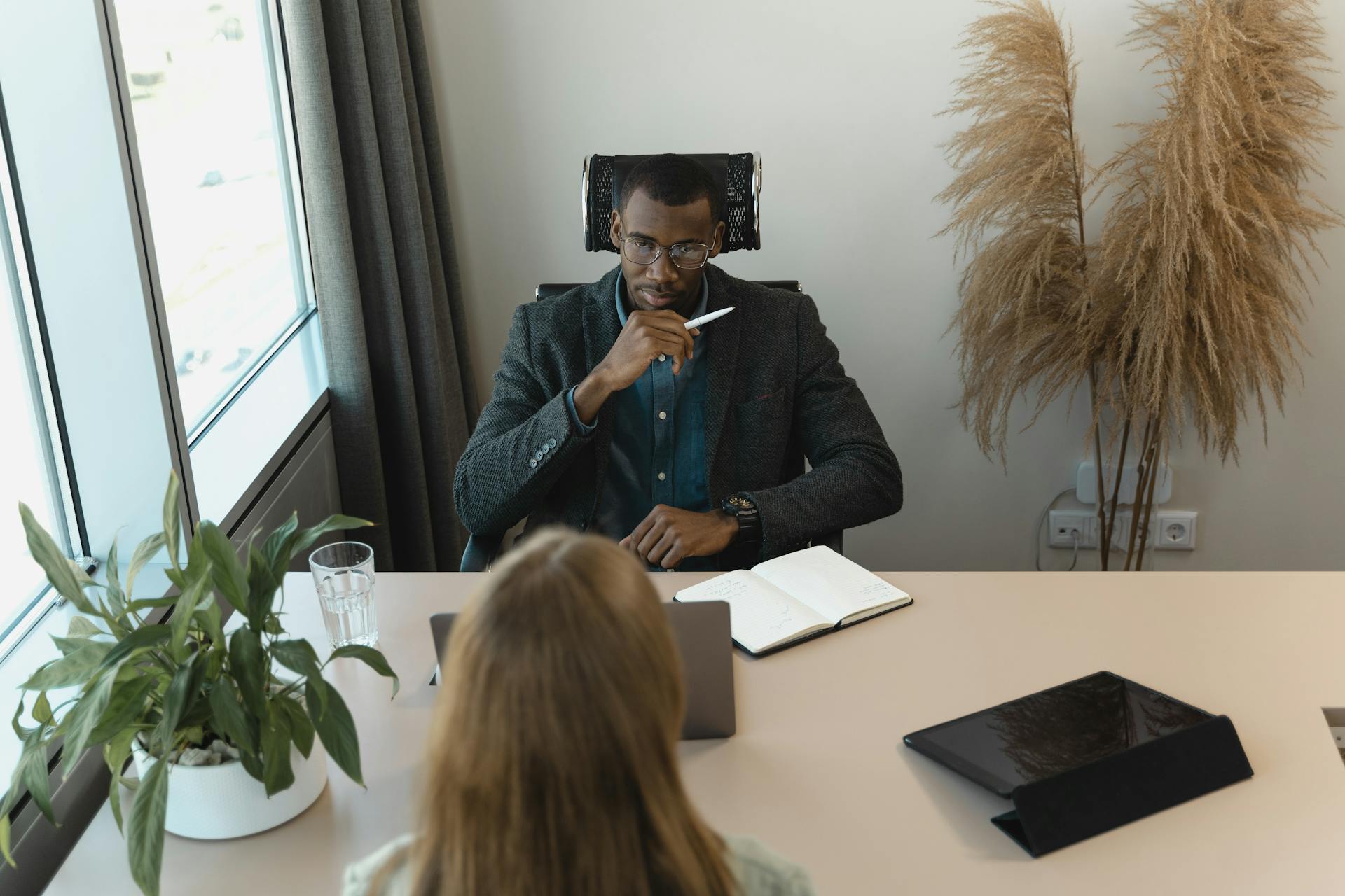 Professional office meeting with diverse team discussing business strategy.