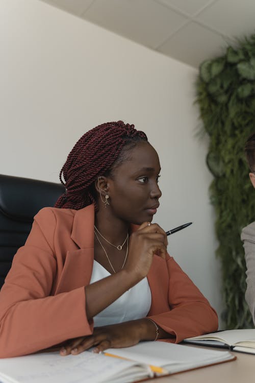 Woman in Blazer Sitting on a Chair