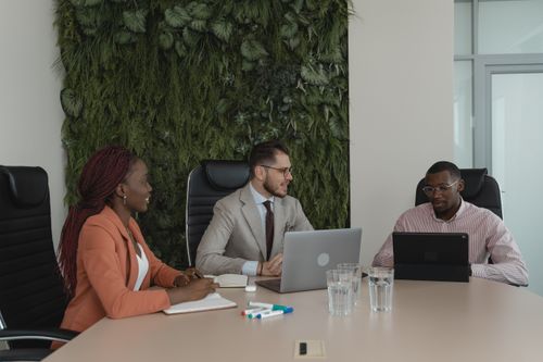 Free A diverse team collaborates in a modern office with vertical garden. Stock Photo
