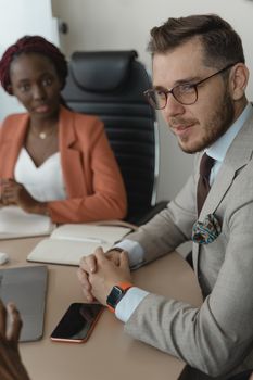 Two business professionals engaged in a meeting at the office.