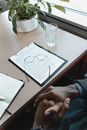Person Holding White Paper on Table