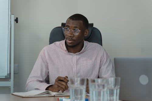 A Businessman Sitting on a Chair while Looking Afar