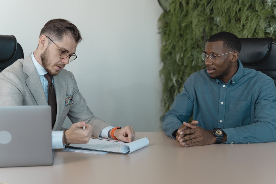 Free Man in Professional Clothing Reading a Resume Stock Photo