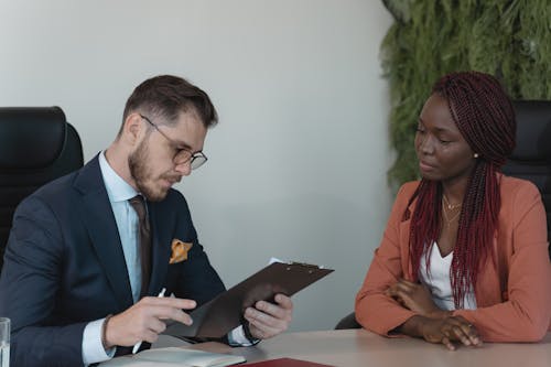 Man Reviewing Woman's Resume