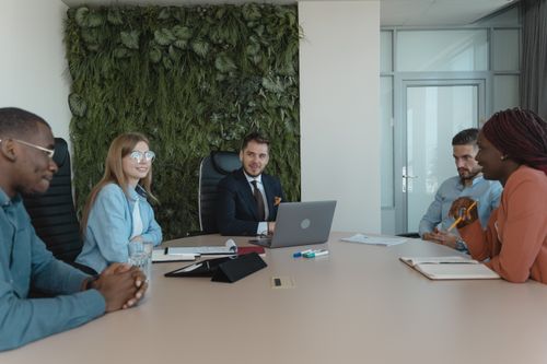 Free A diverse group of professionals engage in a collaborative meeting in a modern office setting. Stock Photo