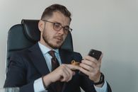 Man in Black Suit Jacket Holding Black Smartphone