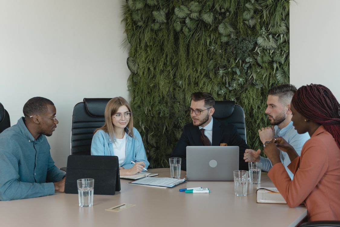 Employees Having a Conversation Inside the Office · Free Stock Photo