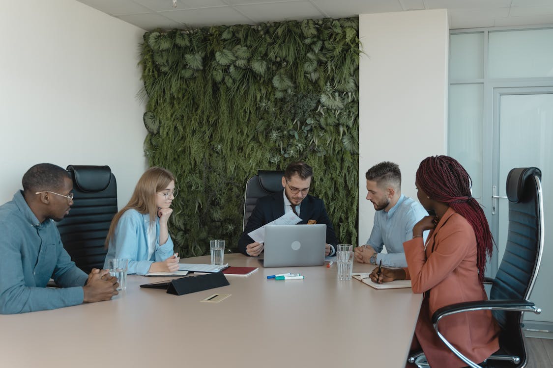 Free Employees in the Meeting Room Having a Discussion Stock Photo