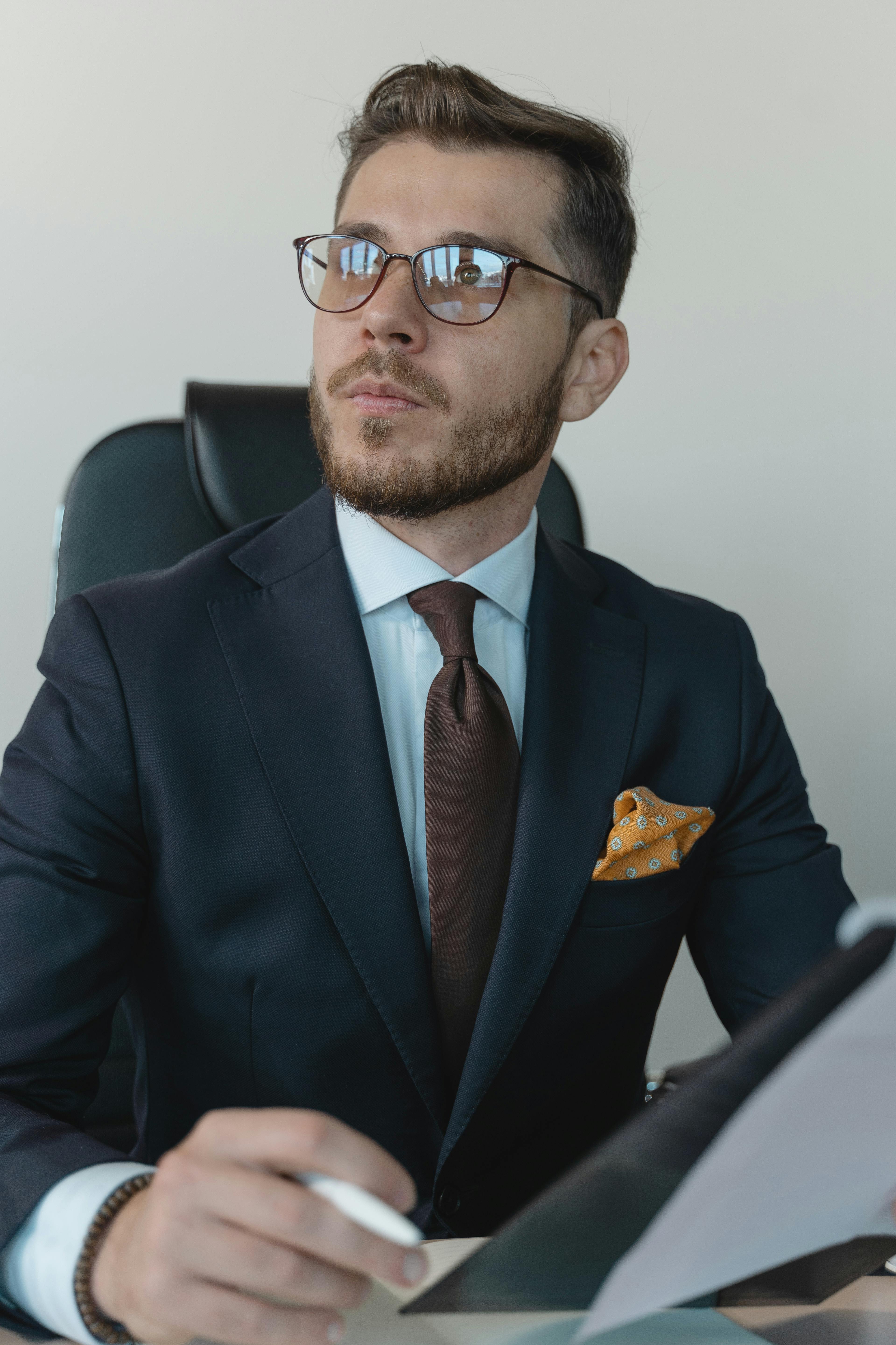 professional in formal attire and black eyeglasses