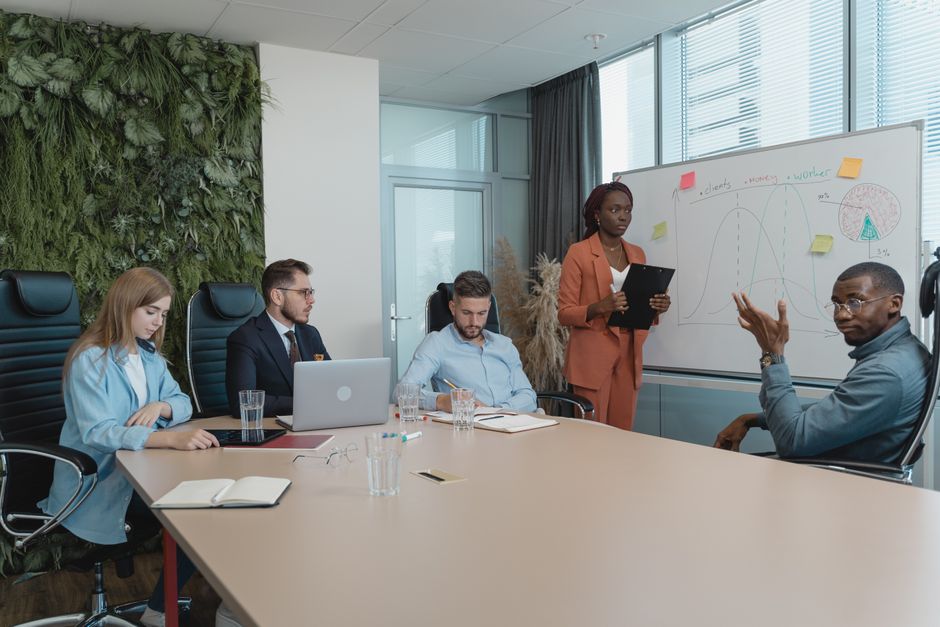 Photo by Tima Miroshnichenko Diverse group of professionals engaged in an innovative brainstorming session in a modern office setting.