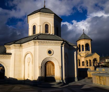 Impressive architecture of an Eastern Orthodox church against a dramatic cloudy sky.