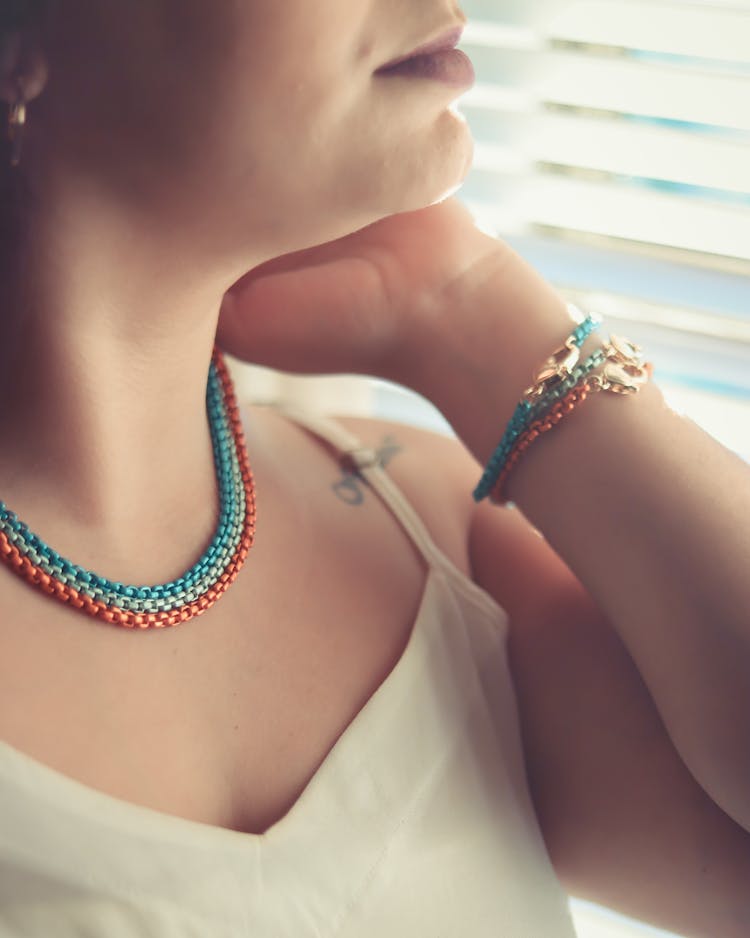 Woman In Wearing Matching Necklaces And Bracelets