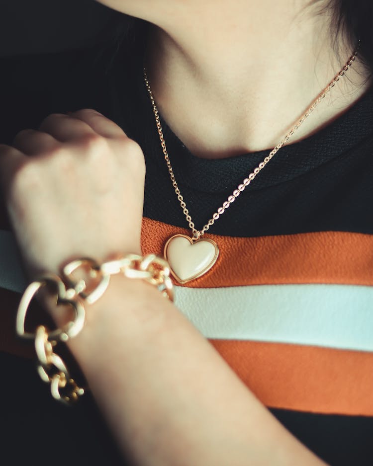 Woman Wearing A Necklace With Heart Pendant And Bracelet