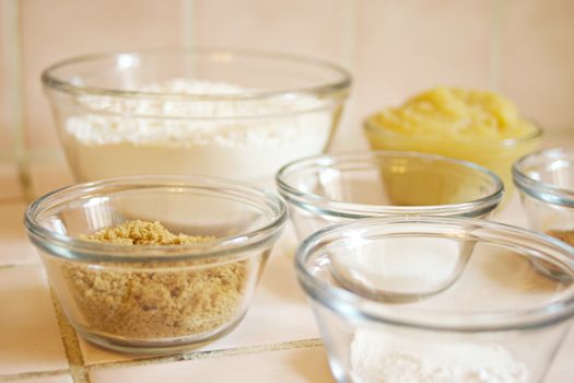 Assorted baking ingredients in glass bowls ready for mixing.