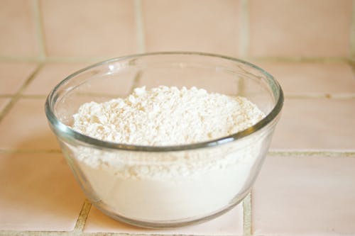 Close-Up Photo of a Glass Bowl with White Flour