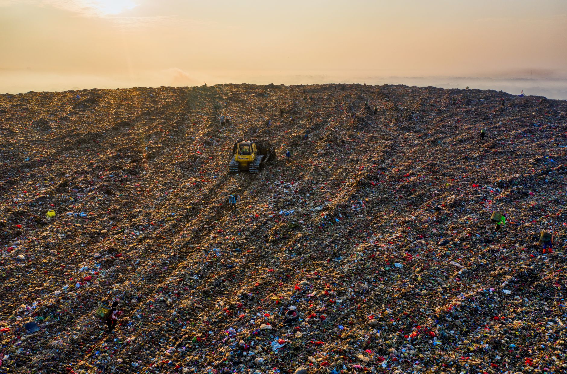 An aerial view of a vast landfill in West Java, highlighting environmental challenges.