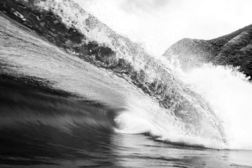 Black and white of foamy ocean big wave with splashing water in tropical country in stormy weather in summer outside