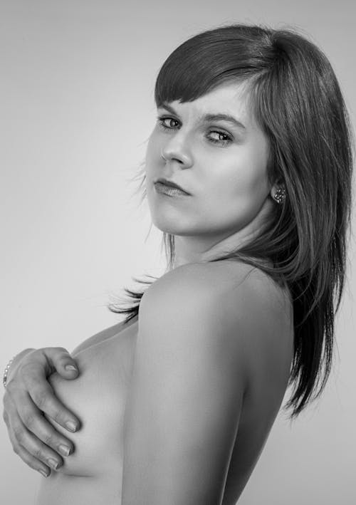 Monochrome Photo of a Naked Woman Looking at the Camera