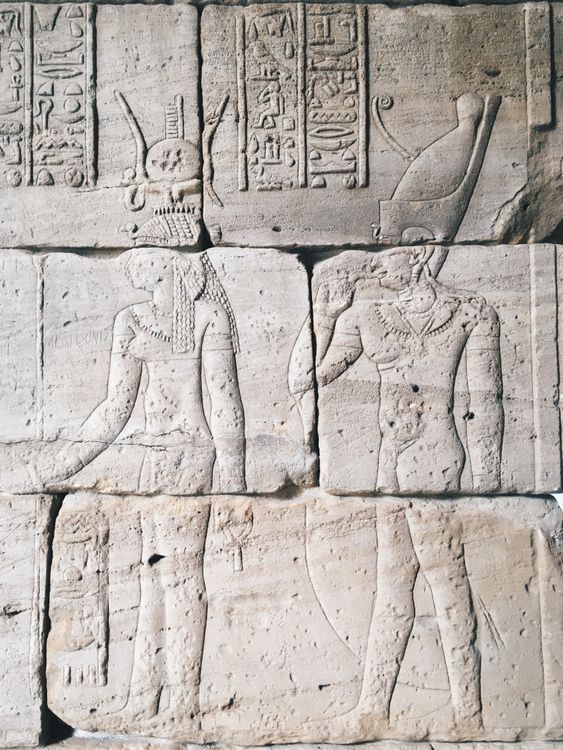 Ancient Carvings on a Stone Wall · Free Stock Photo