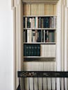 Books on White Wooden Shelf