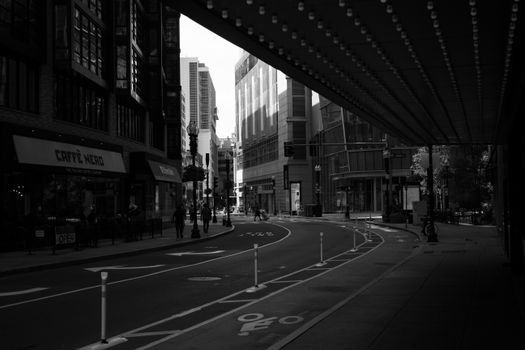 Black and white photo of a curved street in downtown Boston, capturing urban architecture and city life.