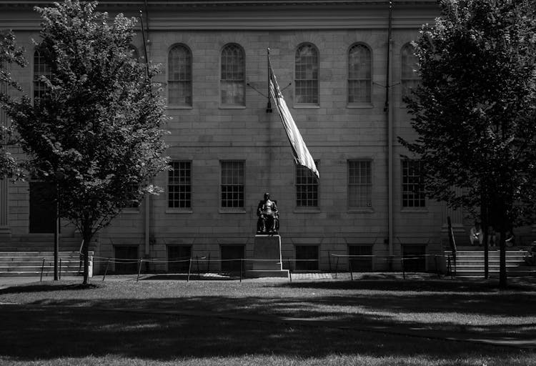 Grayscale Photo Of A Concrete Statue