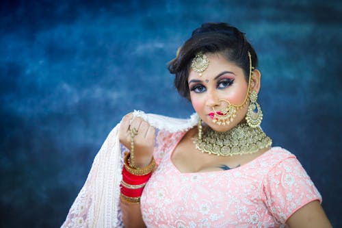 Confident Indian bride wearing traditional clothes and jewelries with makeup