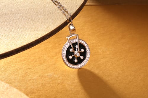 Free Close-Up Photo of a Silver and Black Pendant  Stock Photo