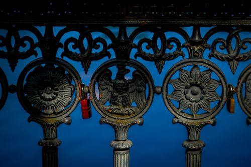 Free Close-up of detailed ornate metal railing with vintage design against blue background. Stock Photo