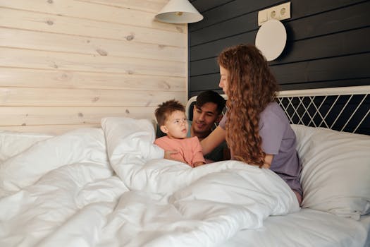 A family enjoying a warm moment together in a cozy bedroom, conveying love and comfort.