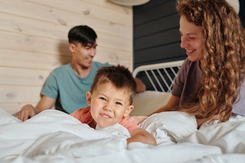 A Family Sitting on the Bed