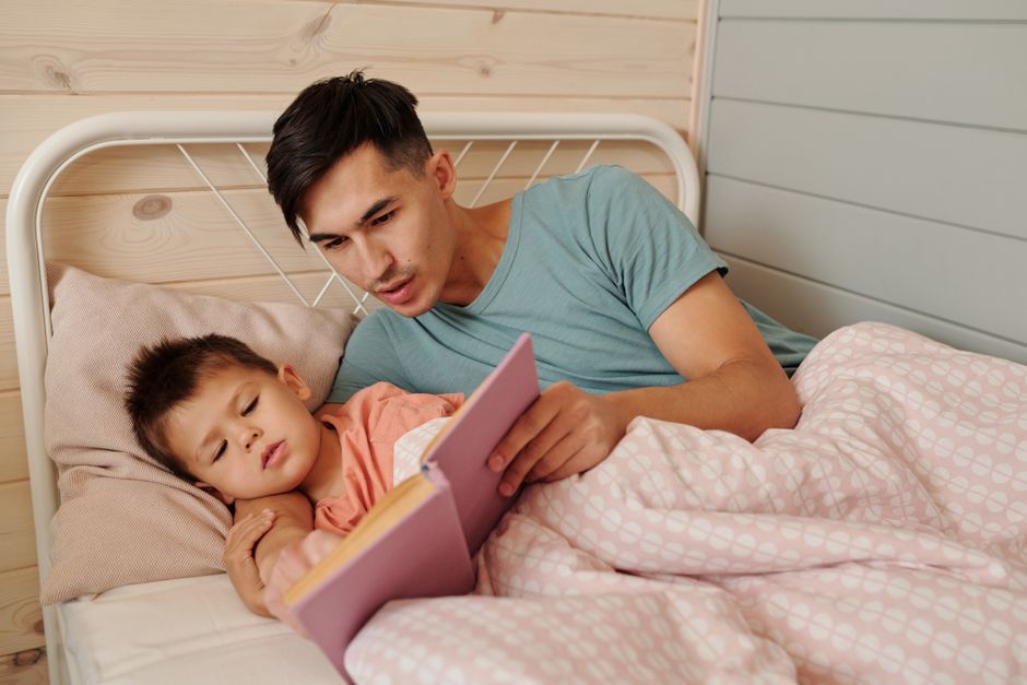 Photo by Werner Pfennig on Pexels Cozy family moment as father reads a bedtime story to his son at home. - Photo by Werner Pfennig on Pexels