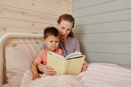 Free Mother and Son Sitting on the Bed Stock Photo