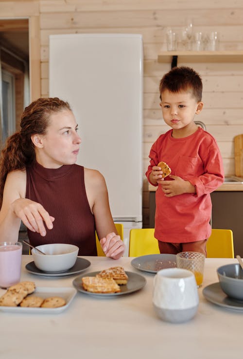 Free Mother and Son Eating at the Table Stock Photo