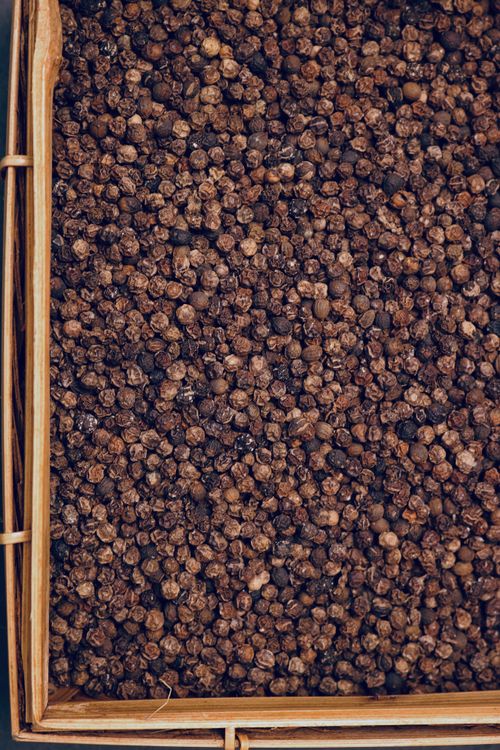 Free A detailed view of black peppercorns inside a wicker basket. Stock Photo