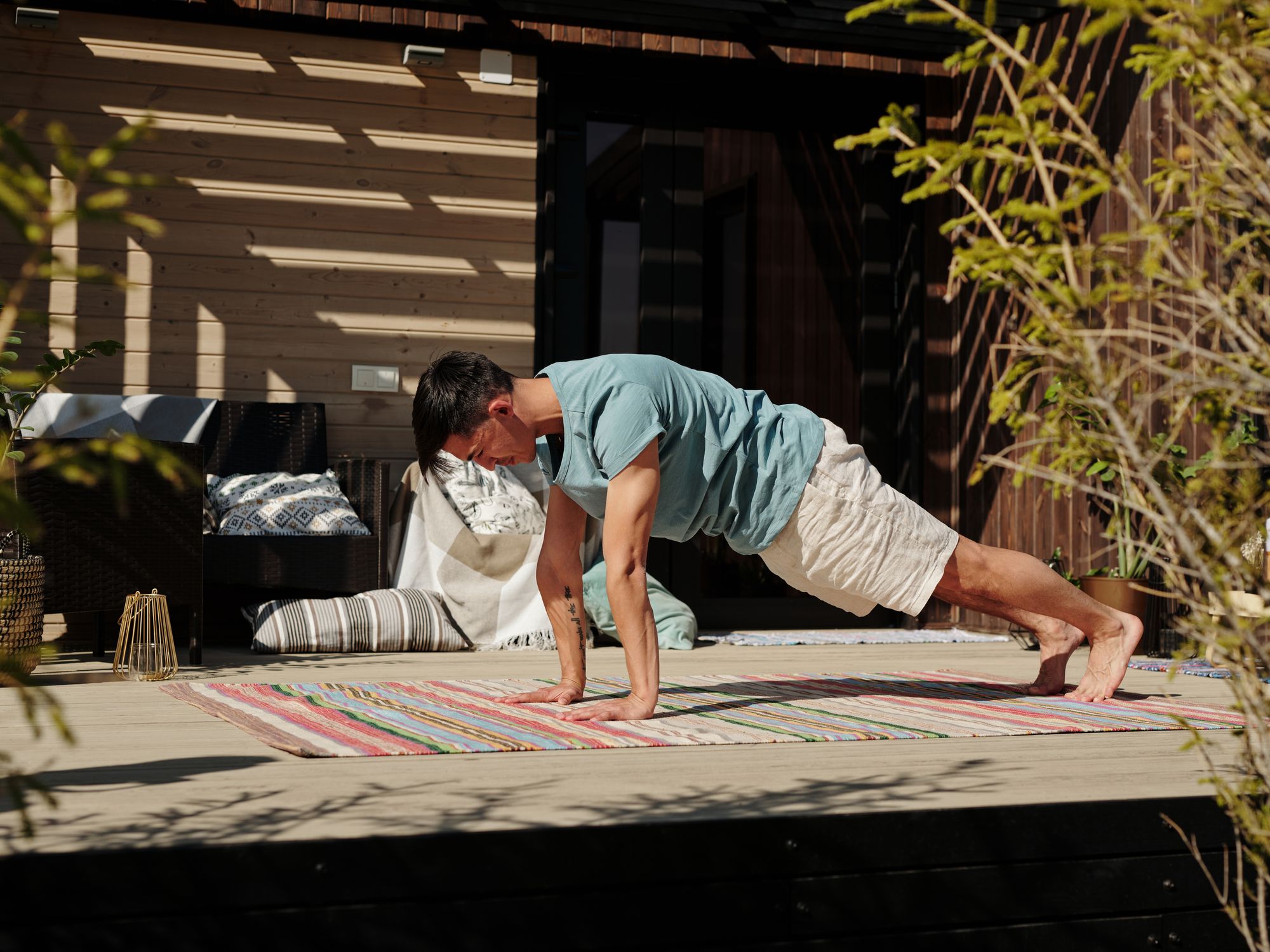 Fence and Decking Painting in South Hornchurch, Havering — garden fence being painted with weatherproof wood finish