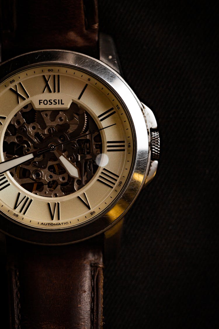 A Fossil Wristwatch On A Black Background