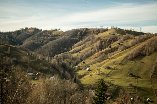 Free Aerial view of the picturesque hills and countryside of Bran, Romania in autumn sunlight. Stock Photo