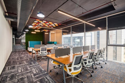 Spacious and modern open office interior with desks and chairs, ideal for business environments.