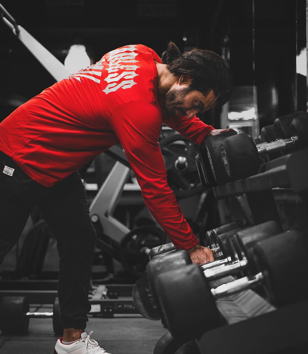 Athlete training in a red long sleeve performance shirt