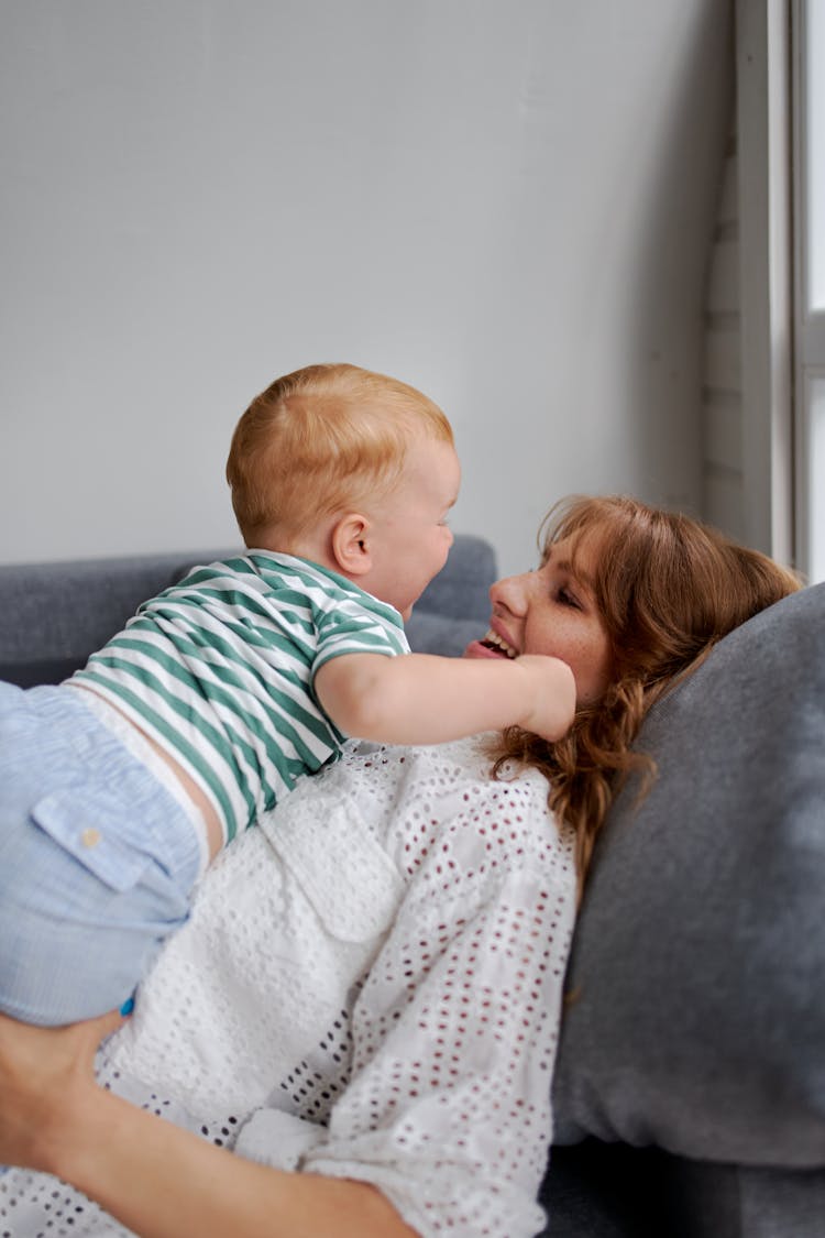 Smiling Woman With Little Boy On Couch