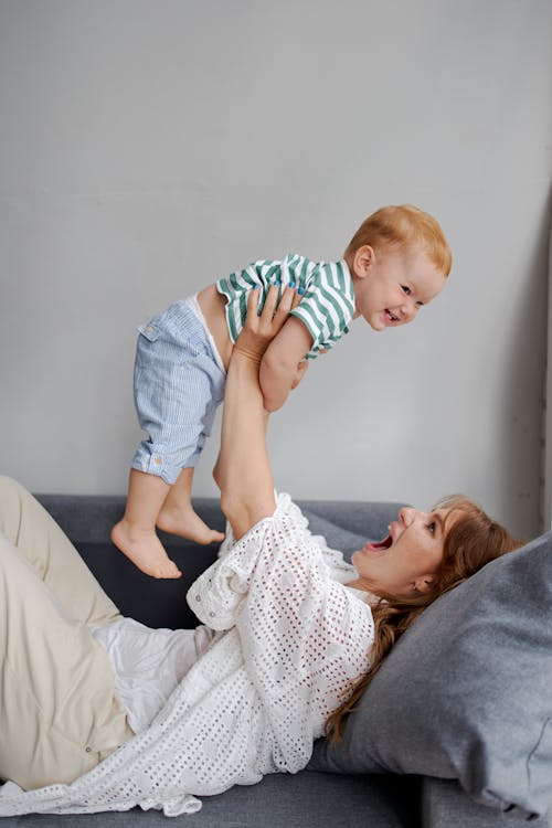 Free Mother and Baby Having Fun Playing in the Living Room Stock Photo