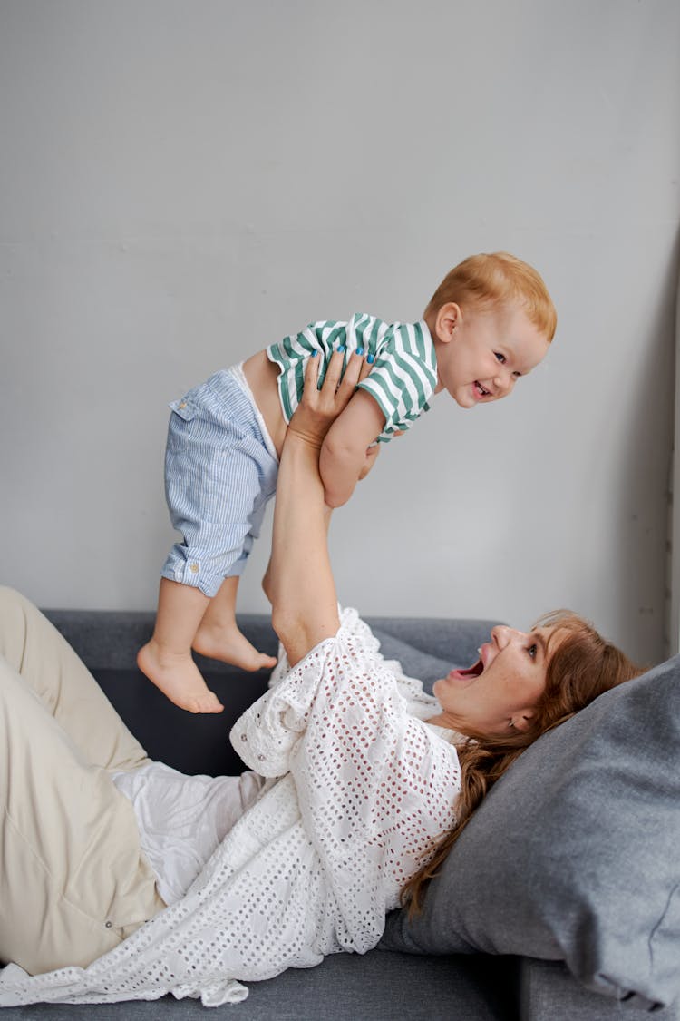 Mother And Baby Having Fun Playing In The Living Room