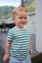 Shy smiling little boy on terrace
