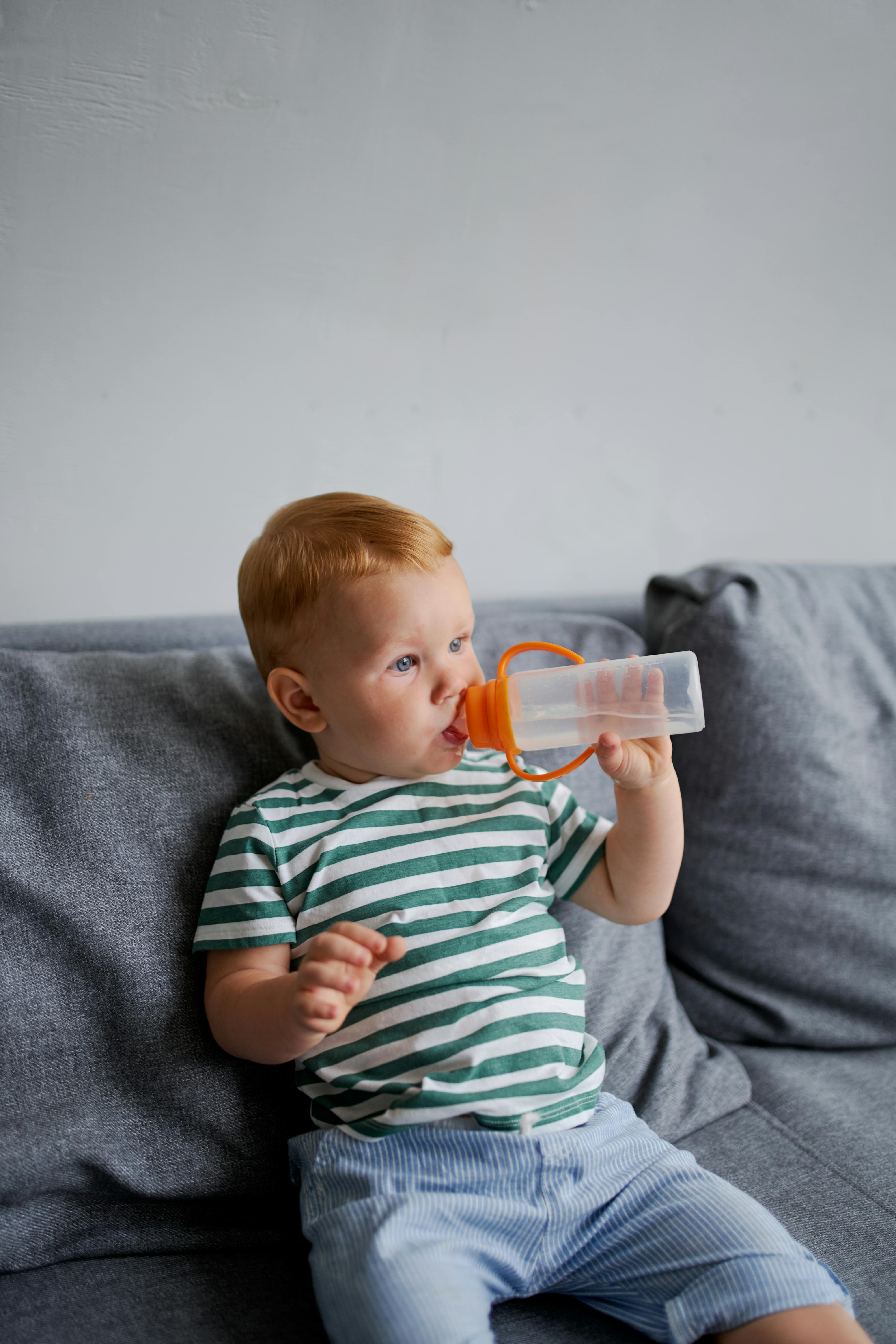 Baby boy drinking with water bottle - Stock image #24733954