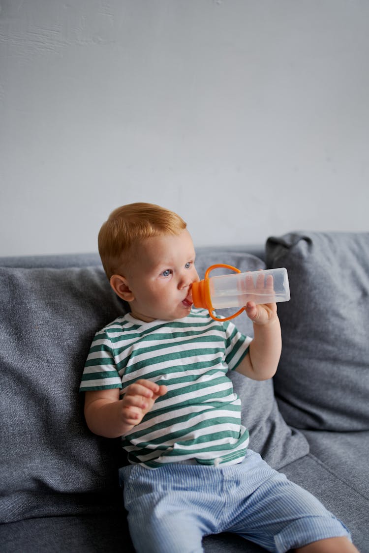 Little Boy Drinking Water From Bottle